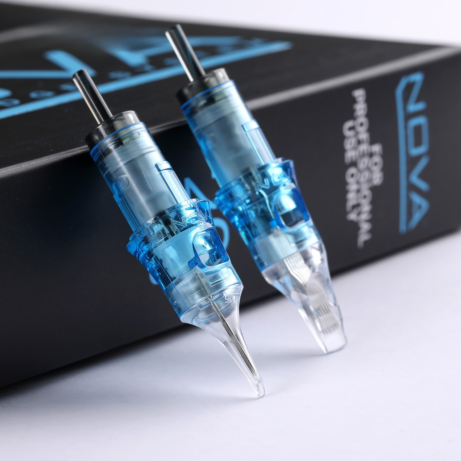 Two blue tattoo needles in front of a black box with 'NOVA' branding.